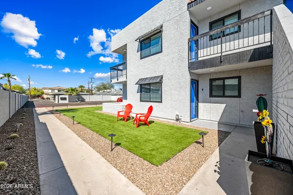 a view of a backyard with sitting area