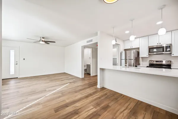a view of kitchen with wooden floor and window
