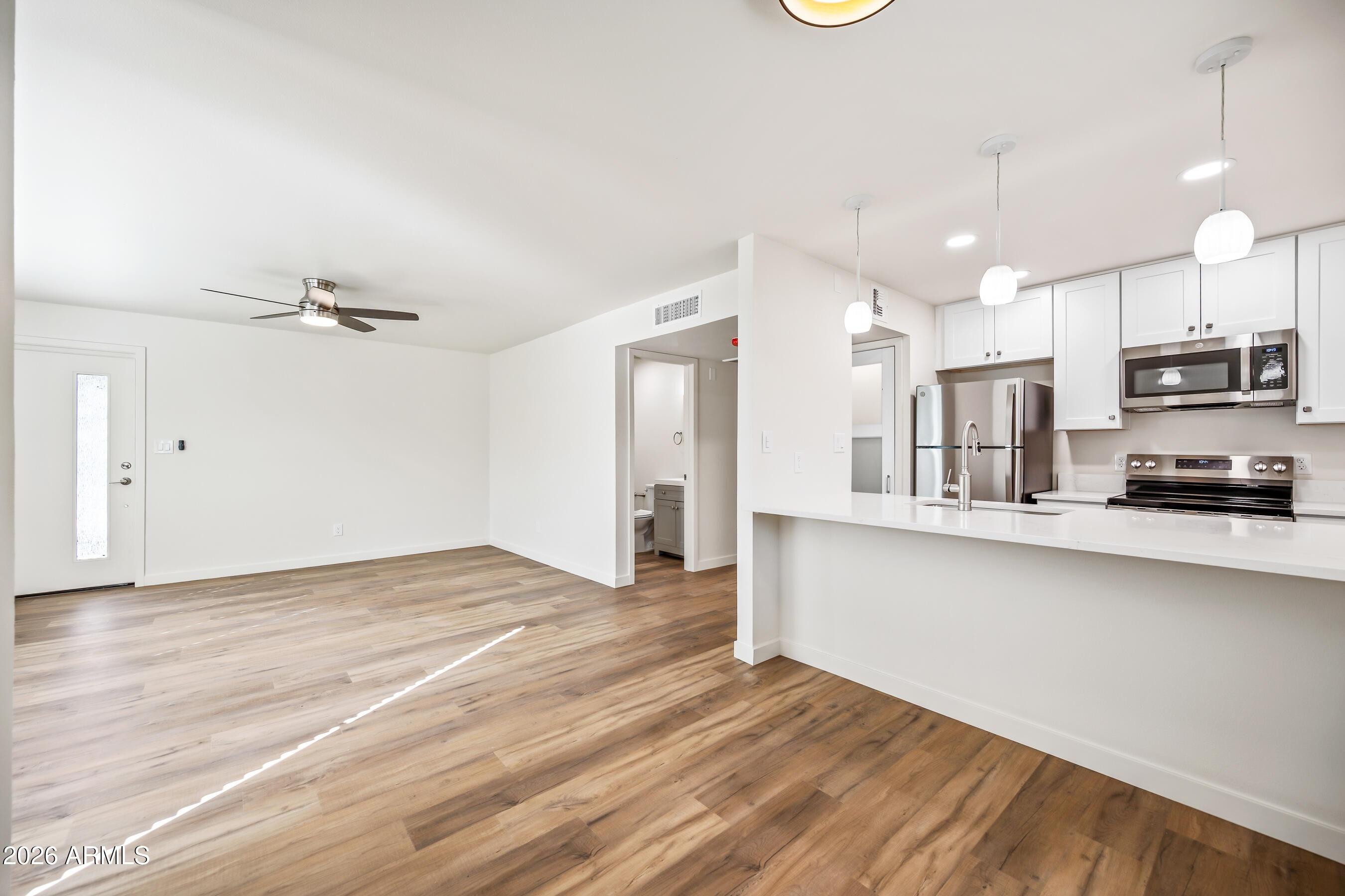 4139 North 27th Street, Unit 3 Phoenix, AZ 85016 - Photo 5 of 30 a view of kitchen with wooden floor and window
