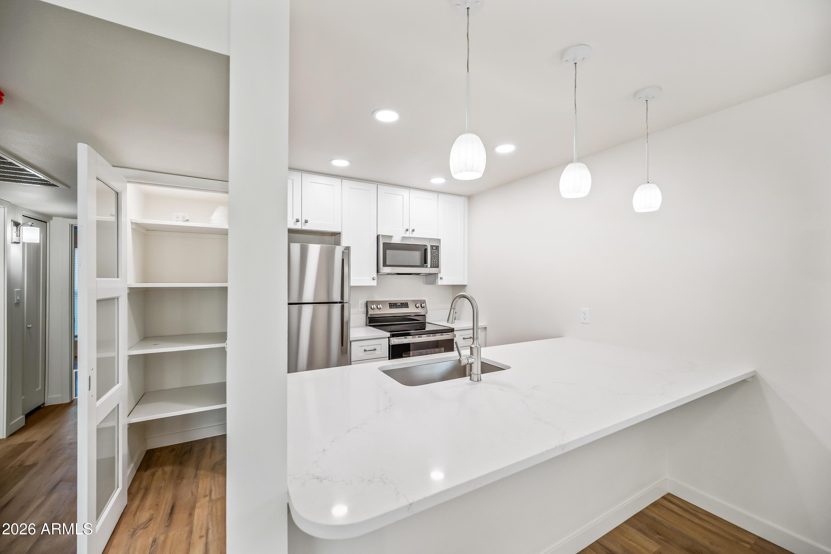 4139 North 27th Street, Unit 3 Phoenix, AZ 85016 - Photo 6 of 30 a kitchen with cabinets and chairs