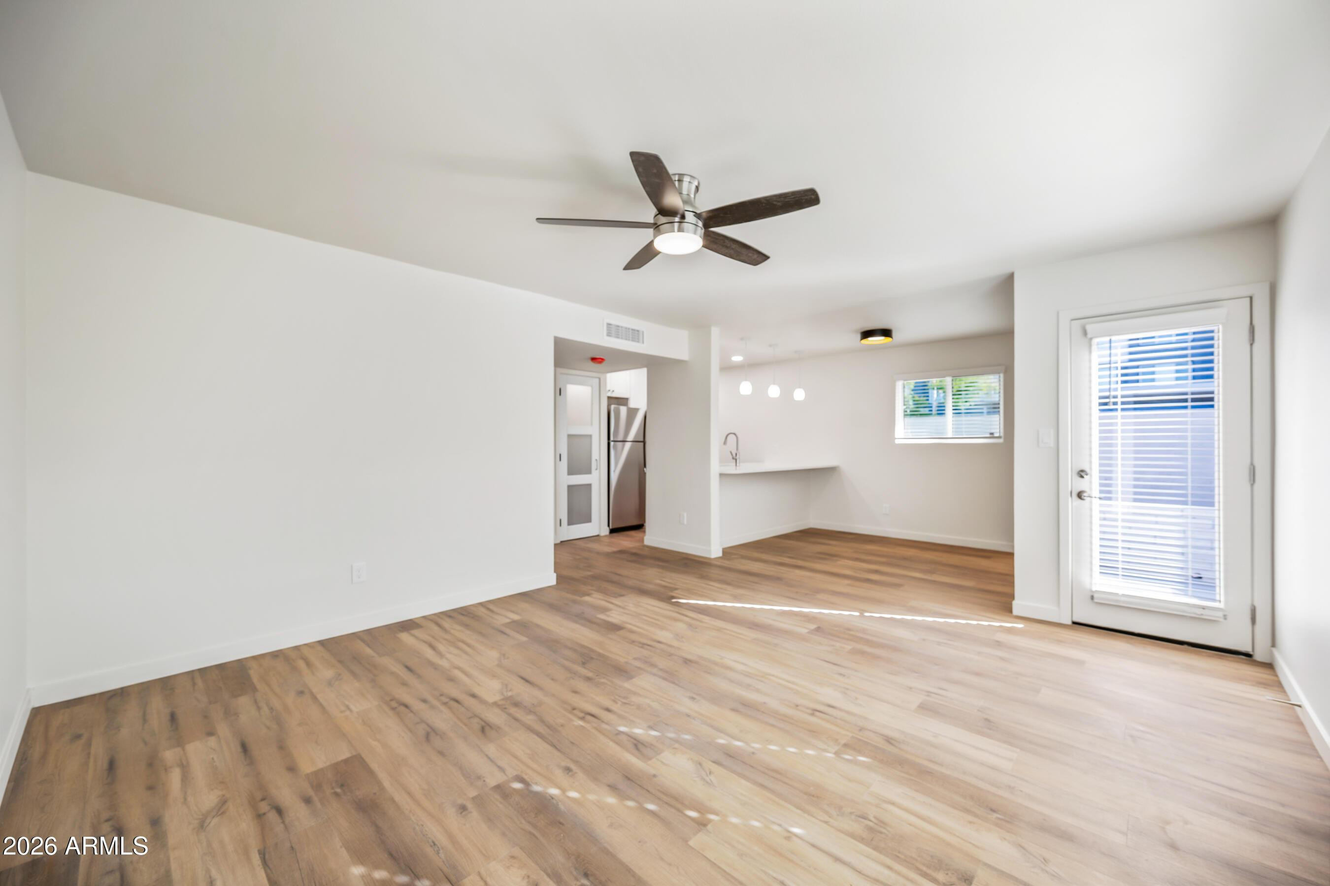 4139 North 27th Street, Unit 3 Phoenix, AZ 85016 - Photo 7 of 30 a view of empty room with wooden floor and ceiling fan