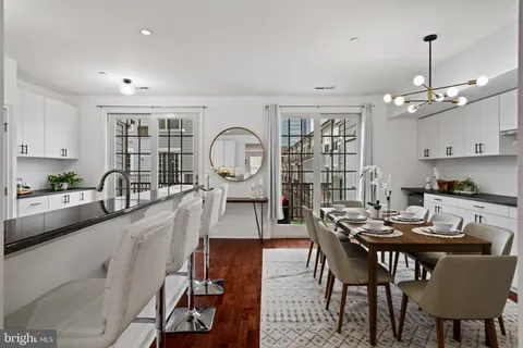 a kitchen with stainless steel appliances granite countertop a sink and a refrigerator