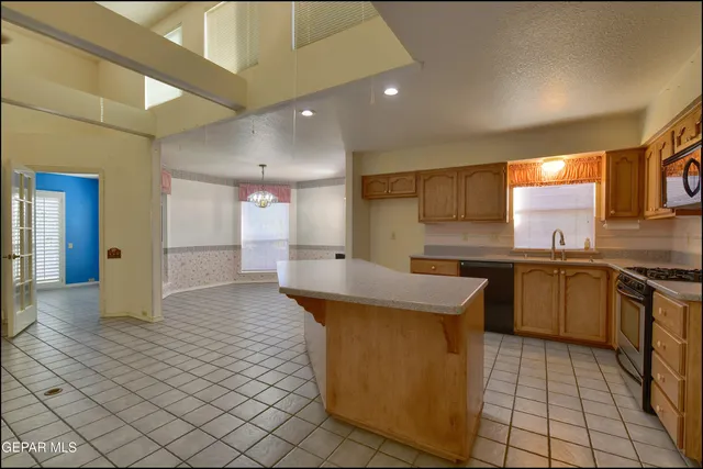 a kitchen with stainless steel appliances granite countertop a sink stove and cabinets