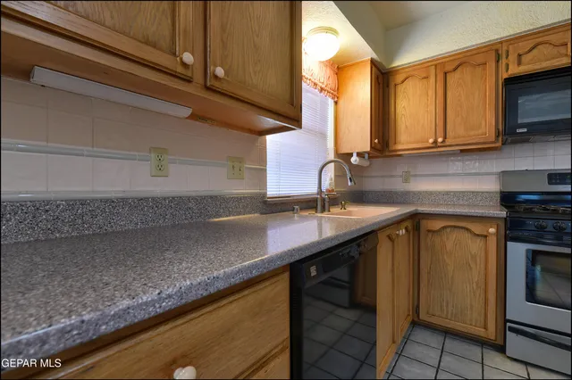 an empty room with windows and chandelier