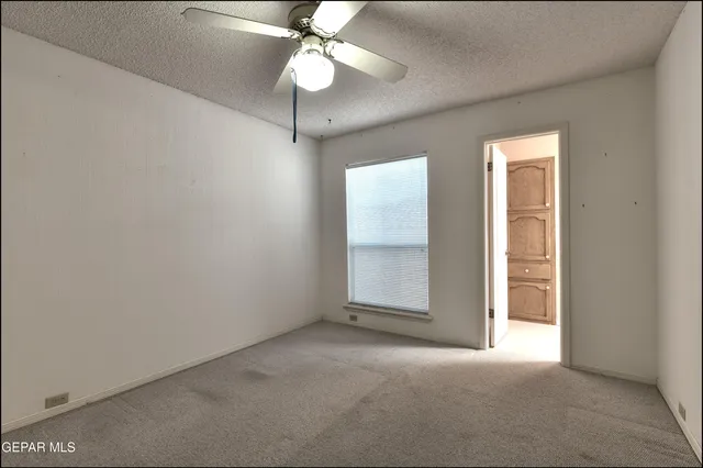 an aerial view of a house with a yard and street