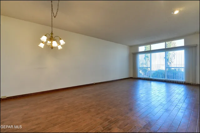 a view of a chandelier fan and wooden floor