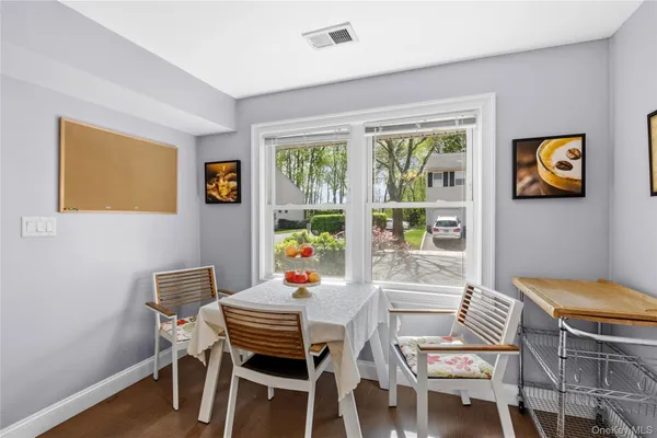 a dining room with furniture and window