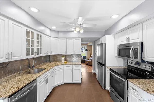 a kitchen with a sink stove microwave and refrigerator