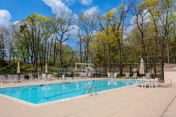 a swimming pool with outdoor seating and yard