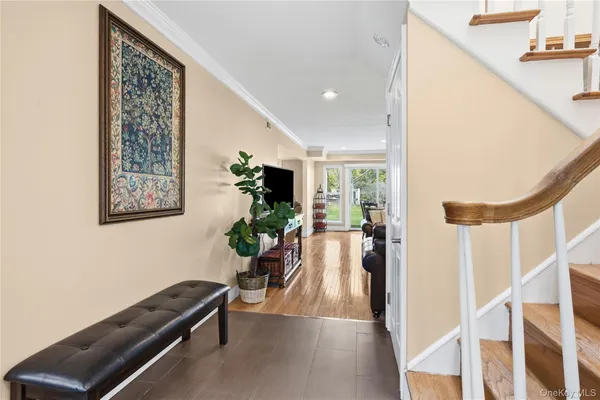 a hallway with furniture and a potted plant
