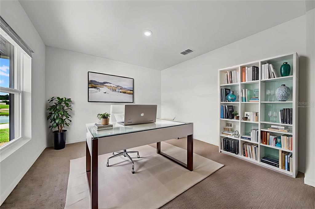 13295 Mylion Way Spring Hill, FL 34610 - Photo 2 of 68 a view of a workspace with a bookshelf