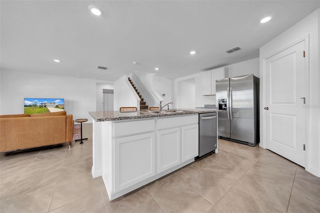 13295 Mylion Way Spring Hill, FL 34610 - Photo 23 of 68 a kitchen with counter top space cabinets and stainless steel appliances