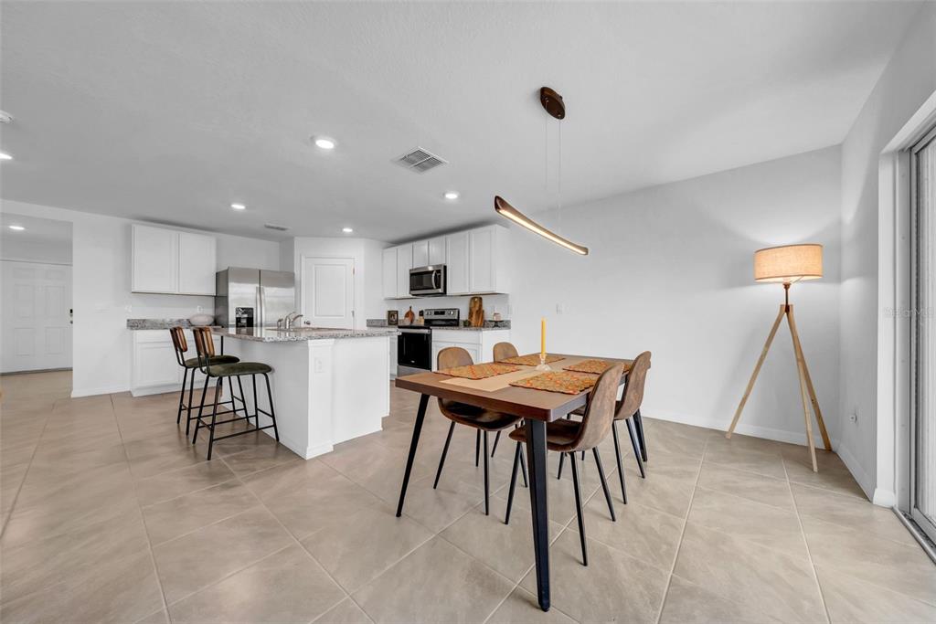 13295 Mylion Way Spring Hill, FL 34610 - Photo 24 of 68 a kitchen with a table and chairs in it