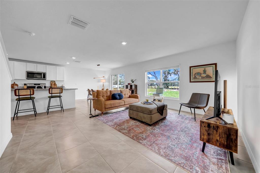 13295 Mylion Way Spring Hill, FL 34610 - Photo 27 of 68 a living room with furniture and a flat screen tv