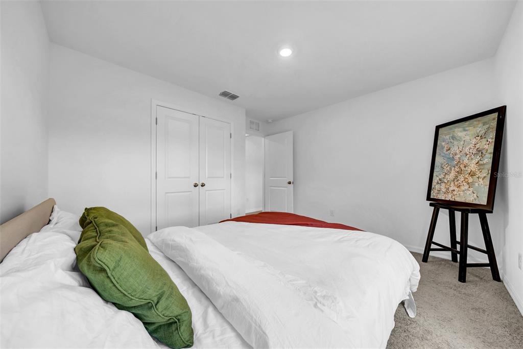 13295 Mylion Way Spring Hill, FL 34610 - Photo 29 of 68 a bedroom with a bed and a table in it