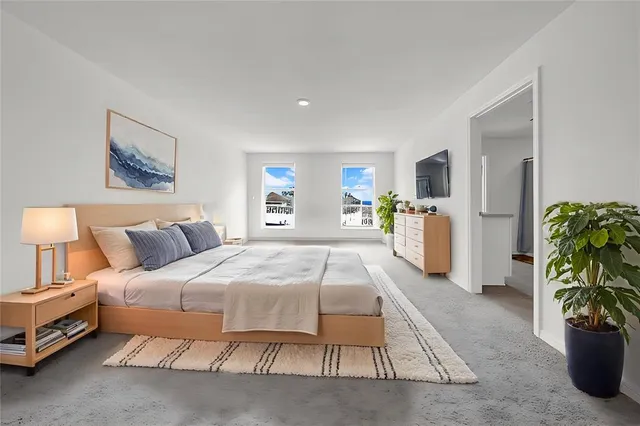 a bedroom with a bed and a night stand