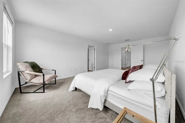 an empty room with windows and garden view