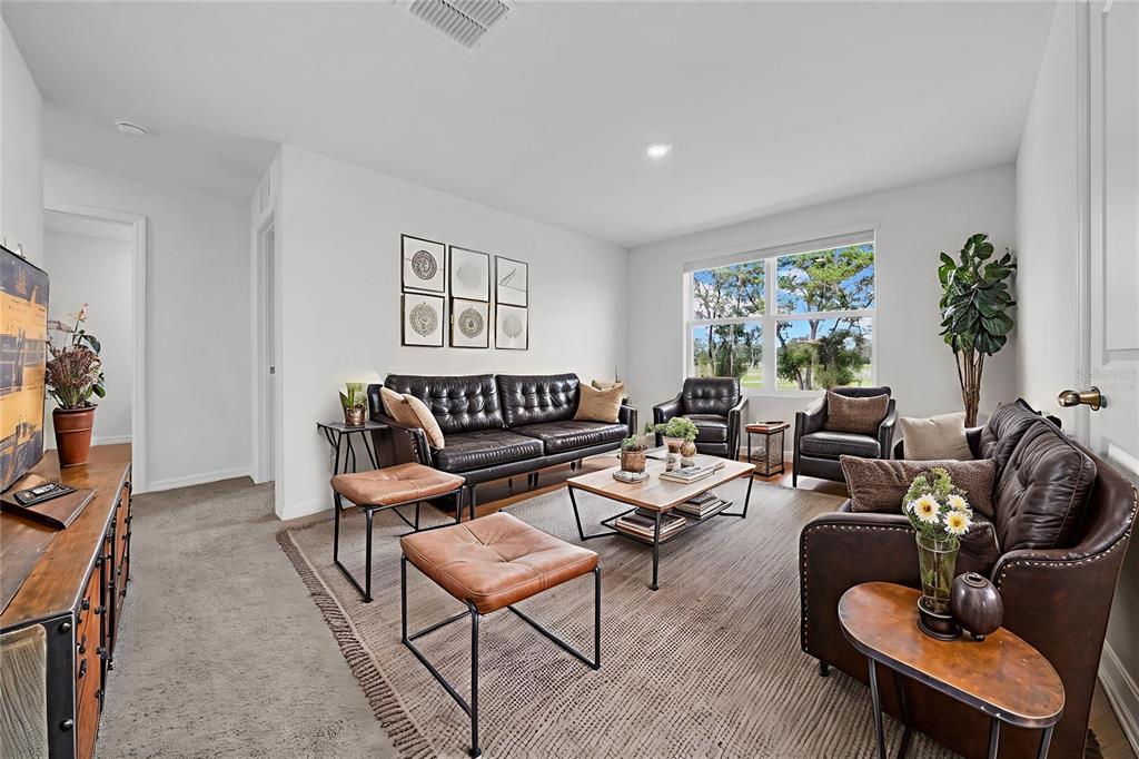 13295 Mylion Way Spring Hill, FL 34610 - Photo 44 of 68 a living room with furniture and a flat screen tv