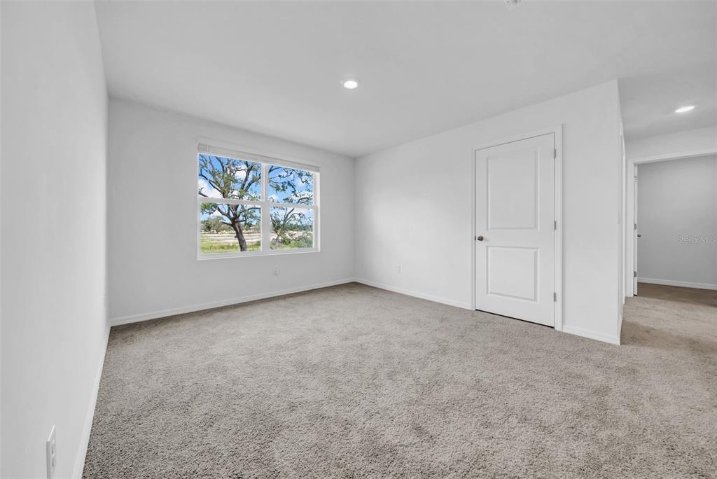 13295 Mylion Way Spring Hill, FL 34610 - Photo 46 of 68 an empty room with windows and garden view