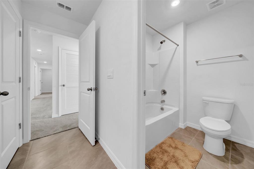 13295 Mylion Way Spring Hill, FL 34610 - Photo 51 of 68 a bathroom with a toilet a sink and bathtub