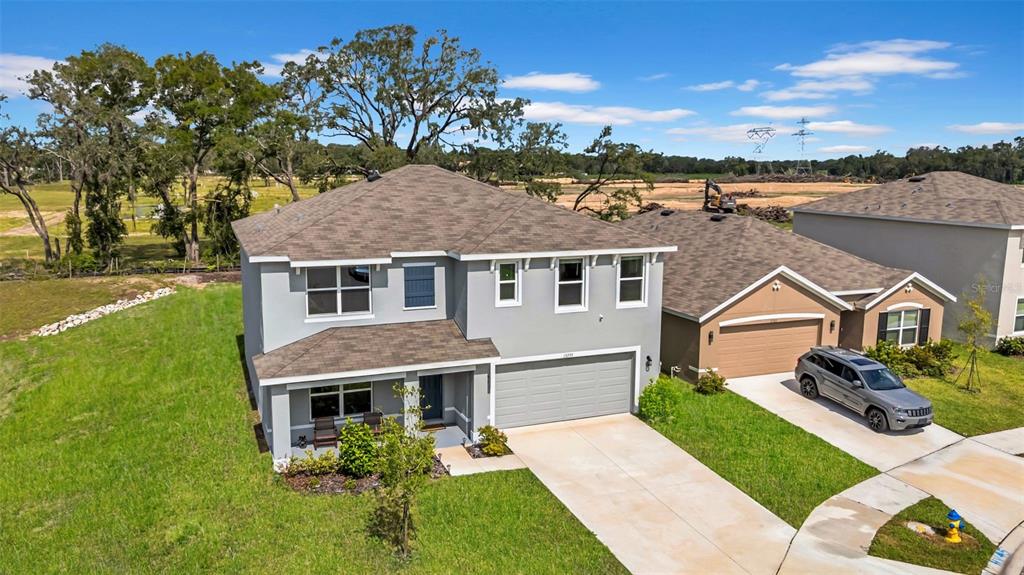 13295 Mylion Way Spring Hill, FL 34610 - Photo 56 of 68 a aerial view of a house with a yard table and chairs
