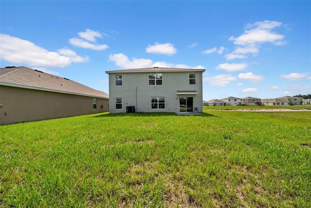13295 Mylion Way Spring Hill, FL 34610 - Photo 10 of 68 a view of a house with a big yard