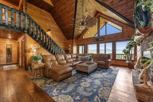 a living room with furniture a fireplace and a table