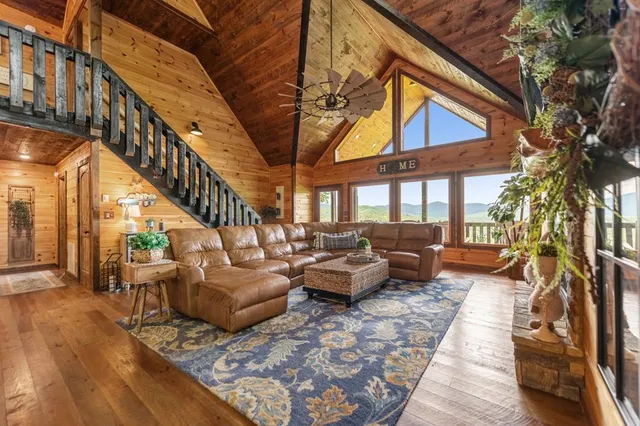 a living room with furniture a window and a fireplace