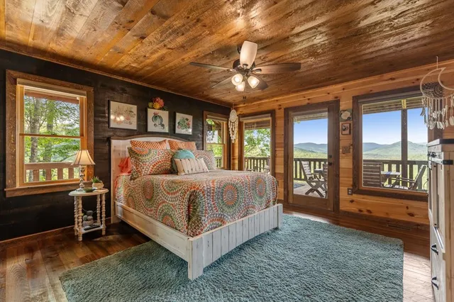 a bedroom with a bed next to a window