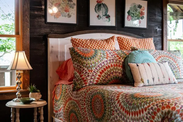 a bed sitting in a bedroom next to a window