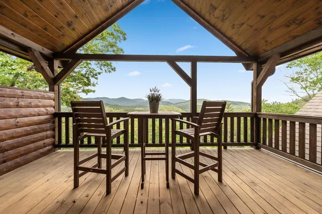 a living room with furniture a ceiling fan and a large window