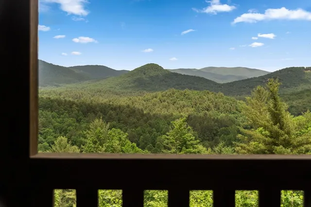 a view of balcony with wooden floor and outdoor seating