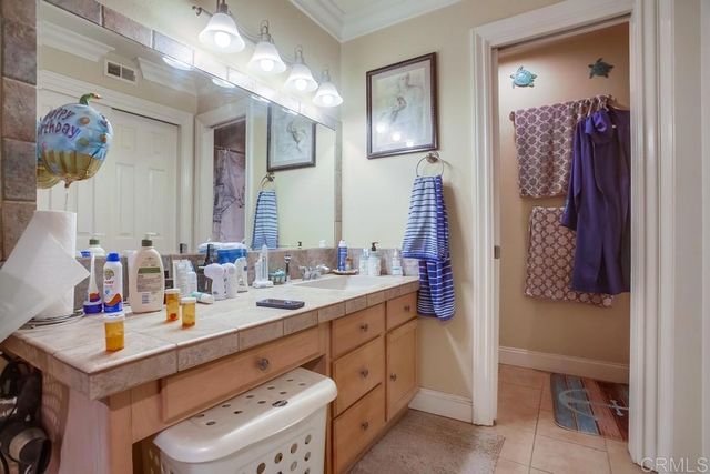 a bathroom with a sink vanity granite and a mirror