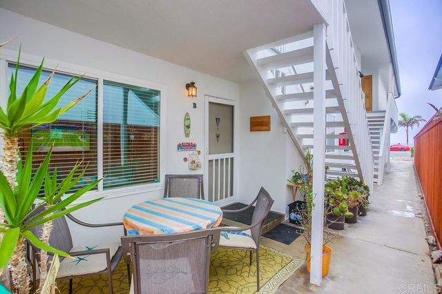 a balcony with furniture and a potted plant