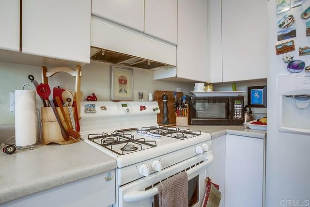 a kitchen with a stove and a refrigerator