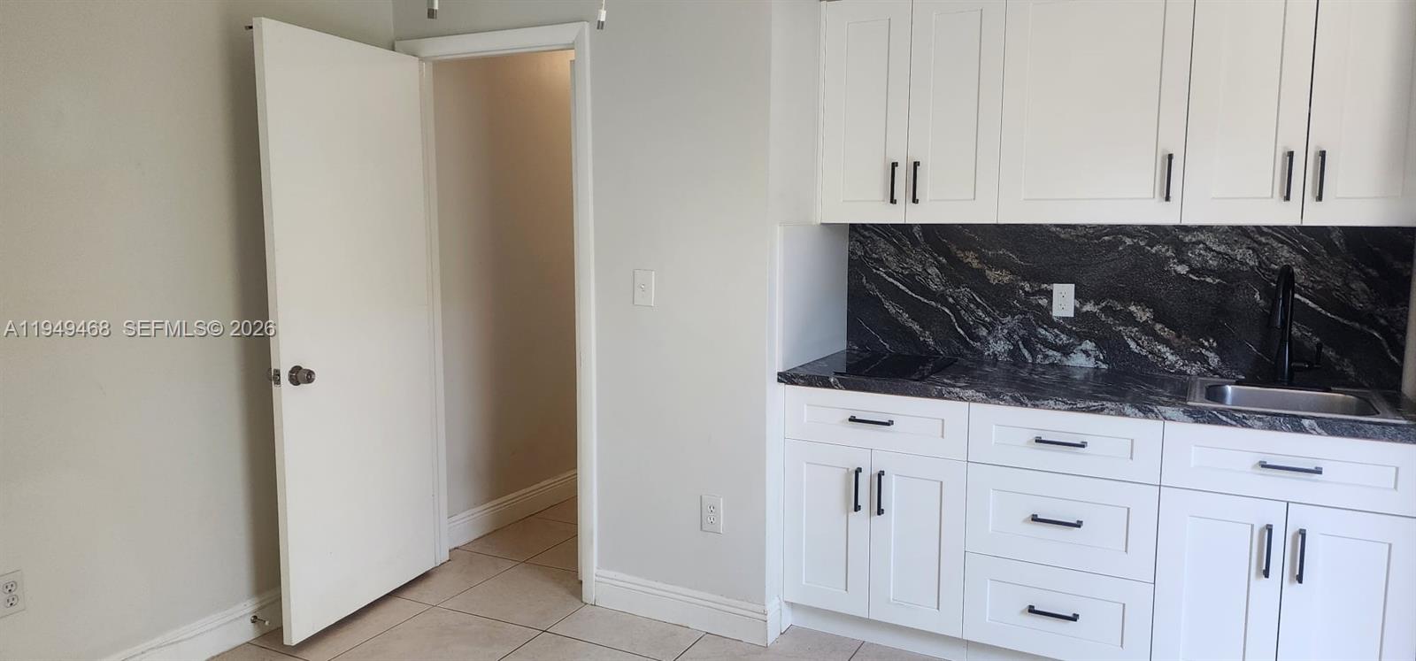 6265 Southwest 31st Street, Unit B Miami, FL 33155 - Photo 16 of 26 a kitchen with white cabinets and white appliances