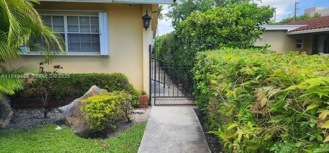 6265 Southwest 31st Street, Unit B Miami, FL 33155 - Photo 20 of 26 a front view of a house with a yard