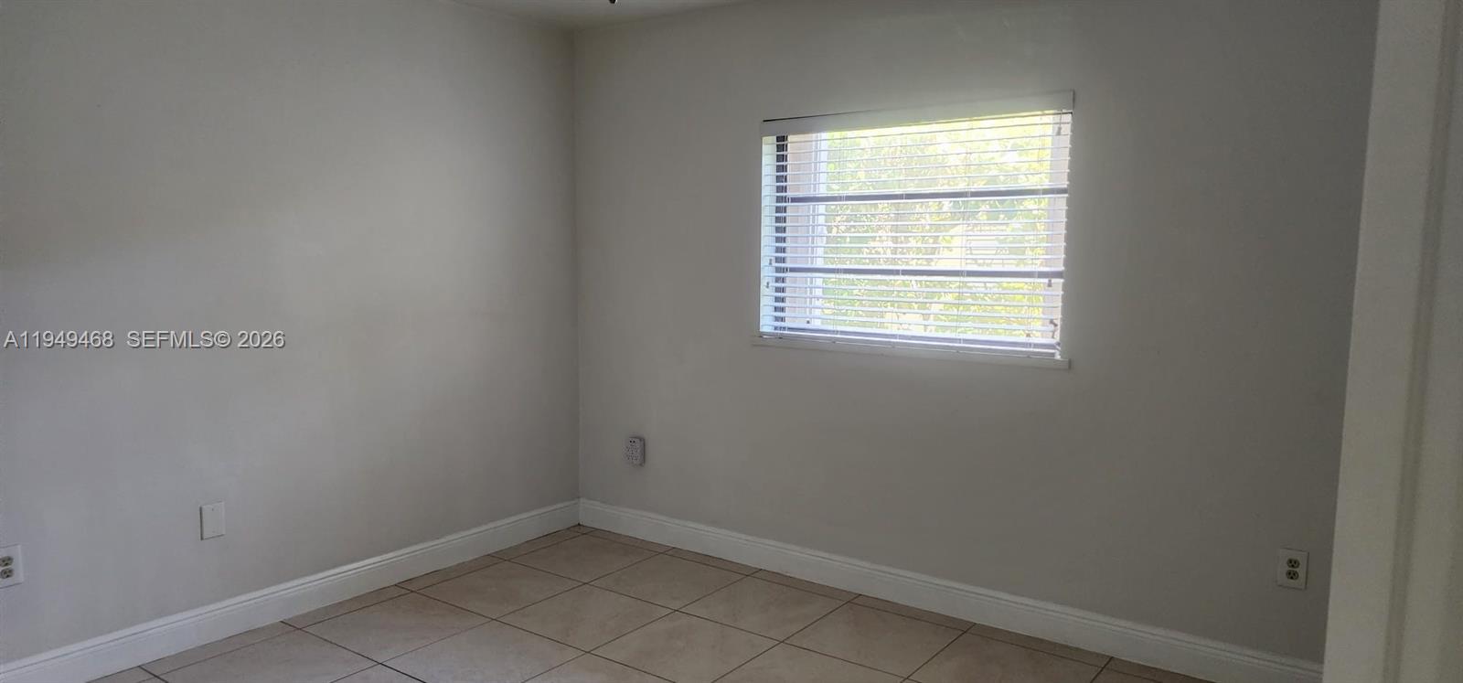 6265 Southwest 31st Street, Unit B Miami, FL 33155 - Photo 22 of 26 an empty room with a window