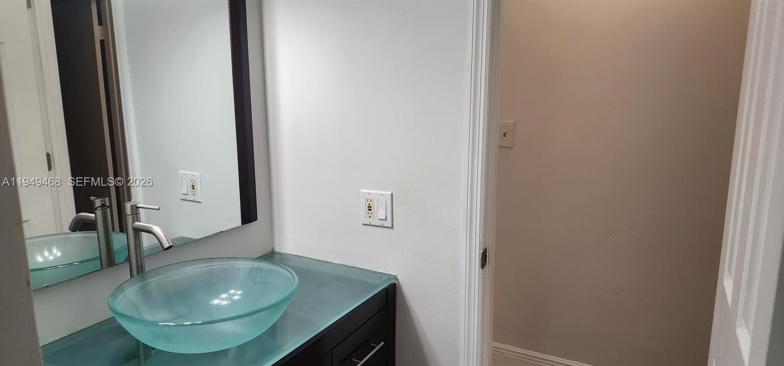 6265 Southwest 31st Street, Unit B Miami, FL 33155 - Photo 24 of 26 a bathroom with a sink and mirror