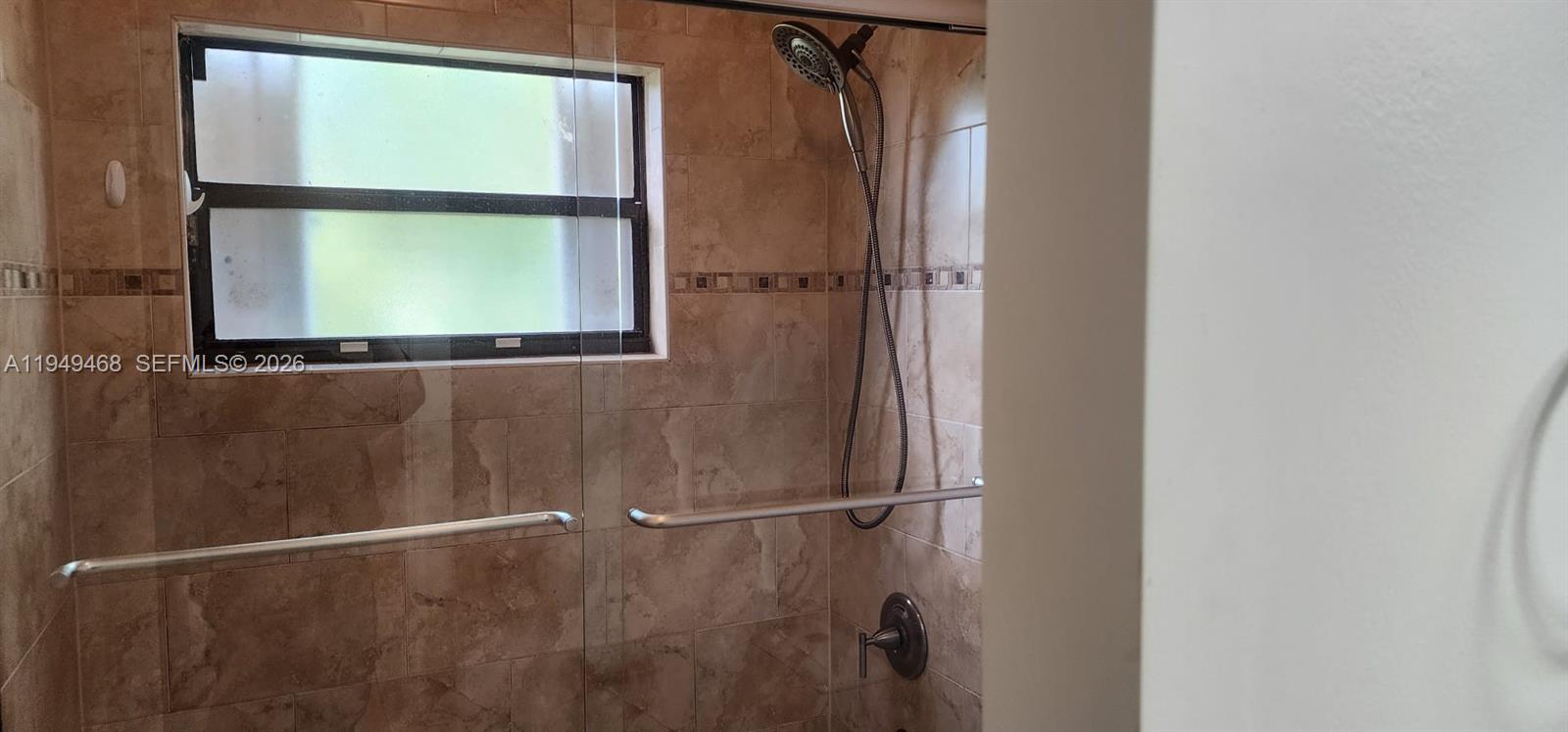 6265 Southwest 31st Street, Unit B Miami, FL 33155 - Photo 26 of 26 a bathroom with a window and a shower