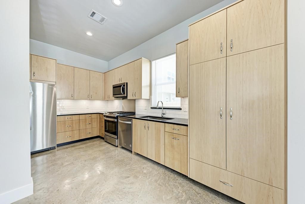 7714 Watson Street, Unit B Austin, TX 78757 - Photo 12 of 40 Open Kitchen; Stainless Steel Appliances; Gas Cooktop