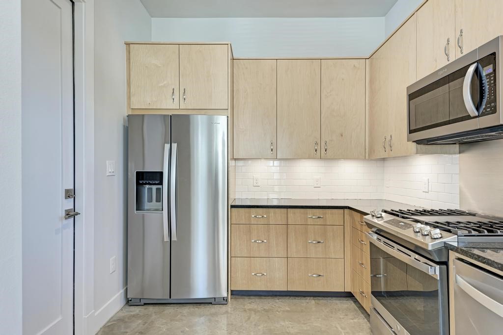 7714 Watson Street, Unit B Austin, TX 78757 - Photo 14 of 40 Stainless Steel Refrigerator side by side; Left Door entry way to single car garage