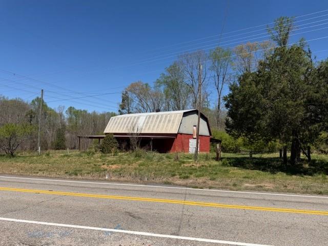 4485 Poplar Springs Road Gainesville, GA 30507 - Photo 2 of 17 a view of a yard in front of a house with large trees