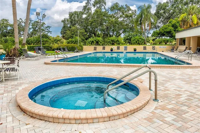 a living room with furniture a large window and potted plants