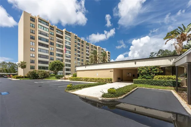 a view of a patio with a table and chairs next to a yard