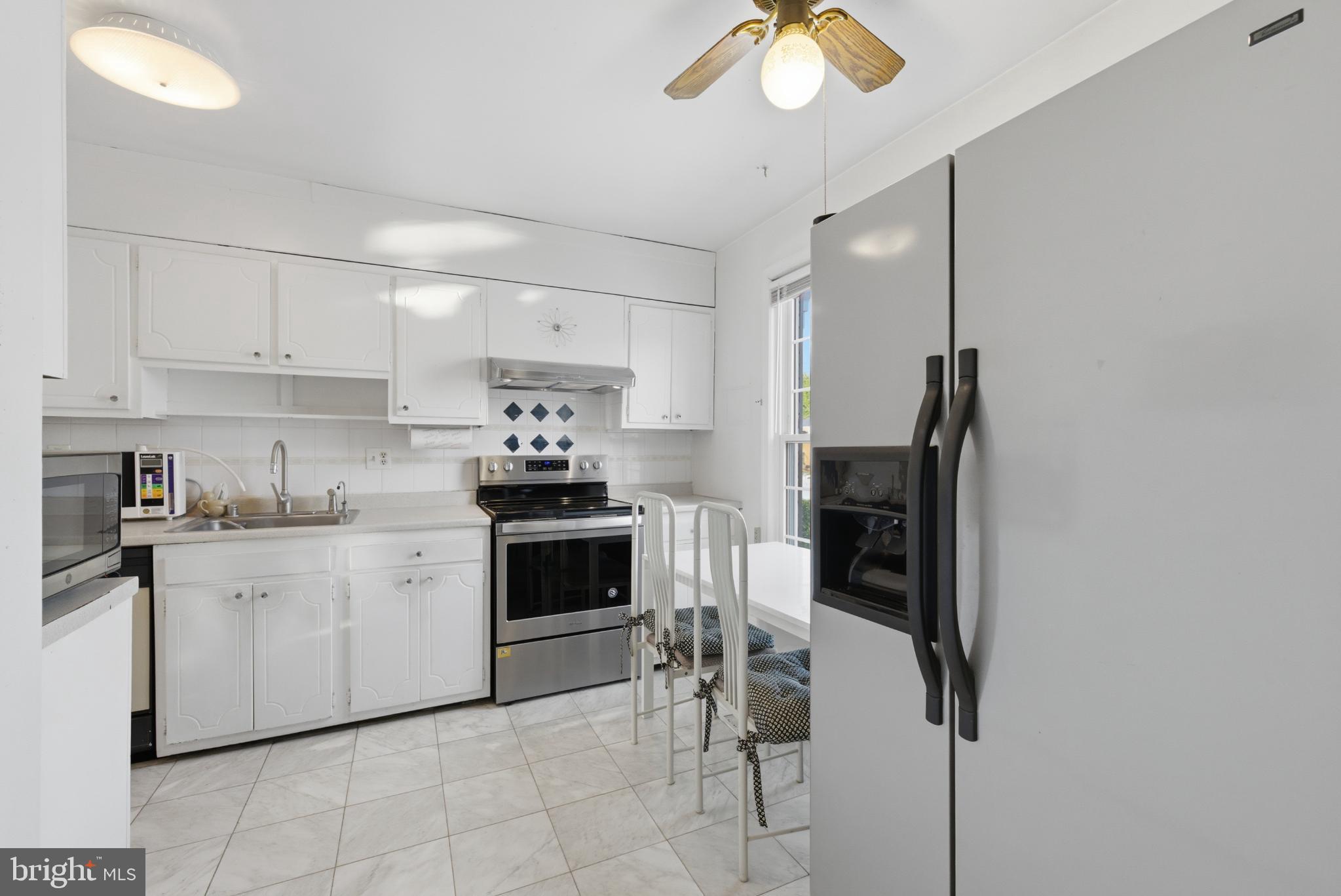 7227 Evanston Road Springfield, VA 22150 - Photo 6 of 44 Bright and airy kitchen with modern appliances.