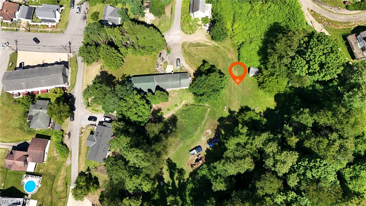 0 Indiana First Street Extension Road Chester, WV 26034 - Photo 17 of 18 Expansive lot featuring a substantial grassy area, surrounded by mature trees, and offering direct road frontage