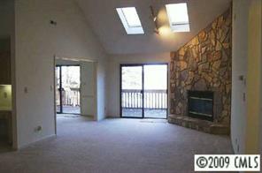 31005 Executive Point Tega Cay, SC 29708 - Photo 4 of 16 a view of an empty room with a fireplace and a window