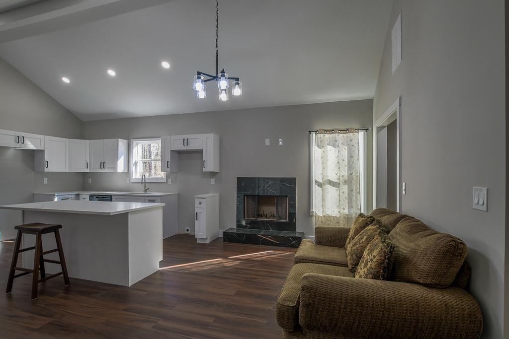 1020 Riverbend Road Commerce, GA 30530 - Photo 11 of 38 a living room with stainless steel appliances granite countertop furniture a fireplace a flat screen tv and a window