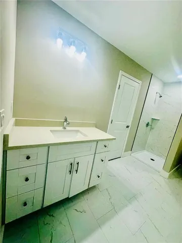 a bathroom with a double vanity sink and mirror